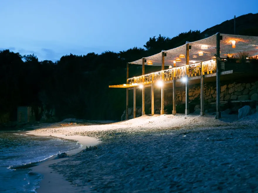 Beach restaurant lit up at night