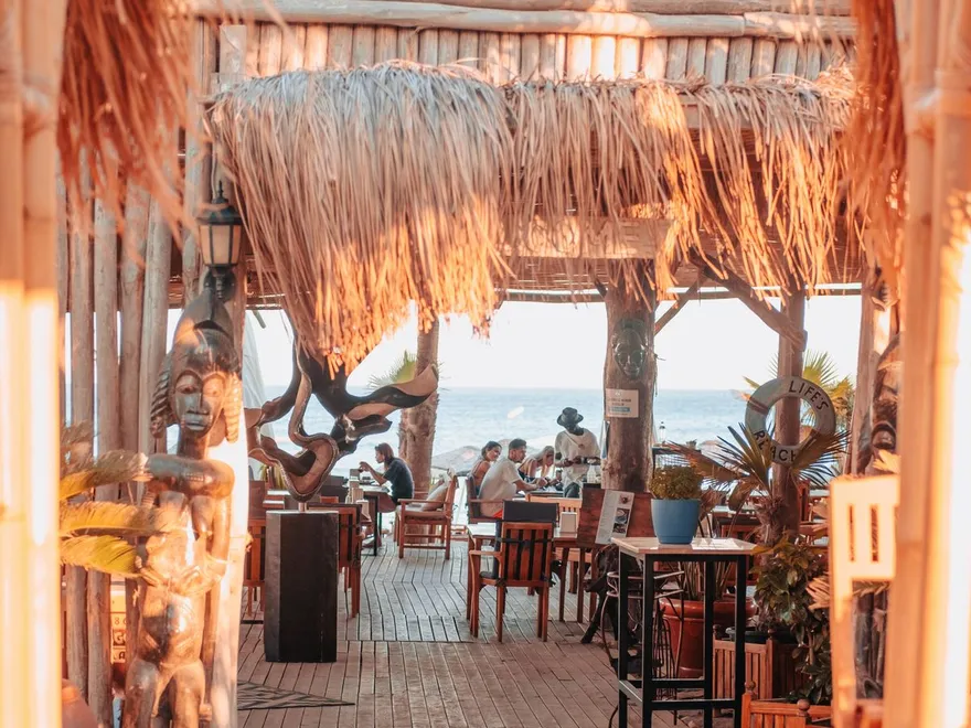 Busy beach bar in golden light